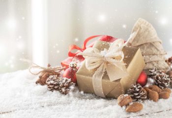 Christmas presents or gifts with elegant bow and christmas decor Christmas presents or gifts with elegant bow and christmas decorations on bright snowy background, christmas concept